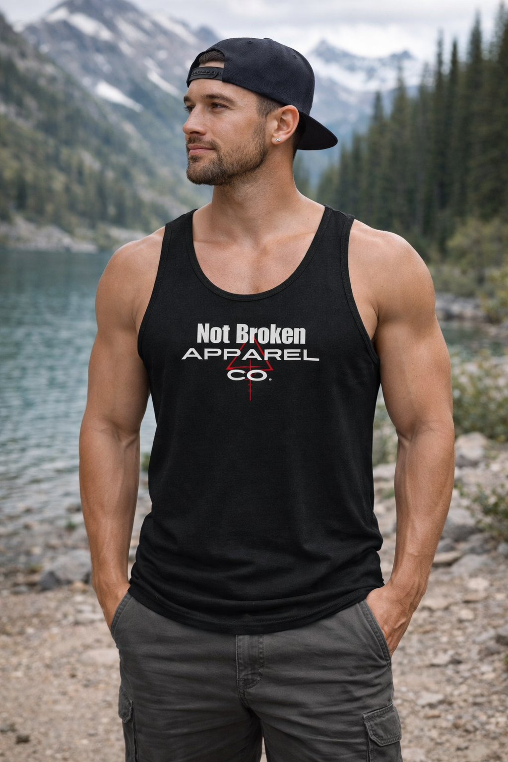 Man wearing a black Not Broken Reticle tank top with a white tactical reticle graphic, designed for focus and precision.