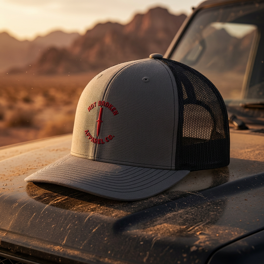 Charcoal gray and black Dagger Snapback Trucker hat with a precision dagger graphic, tactical headwear for veterans.