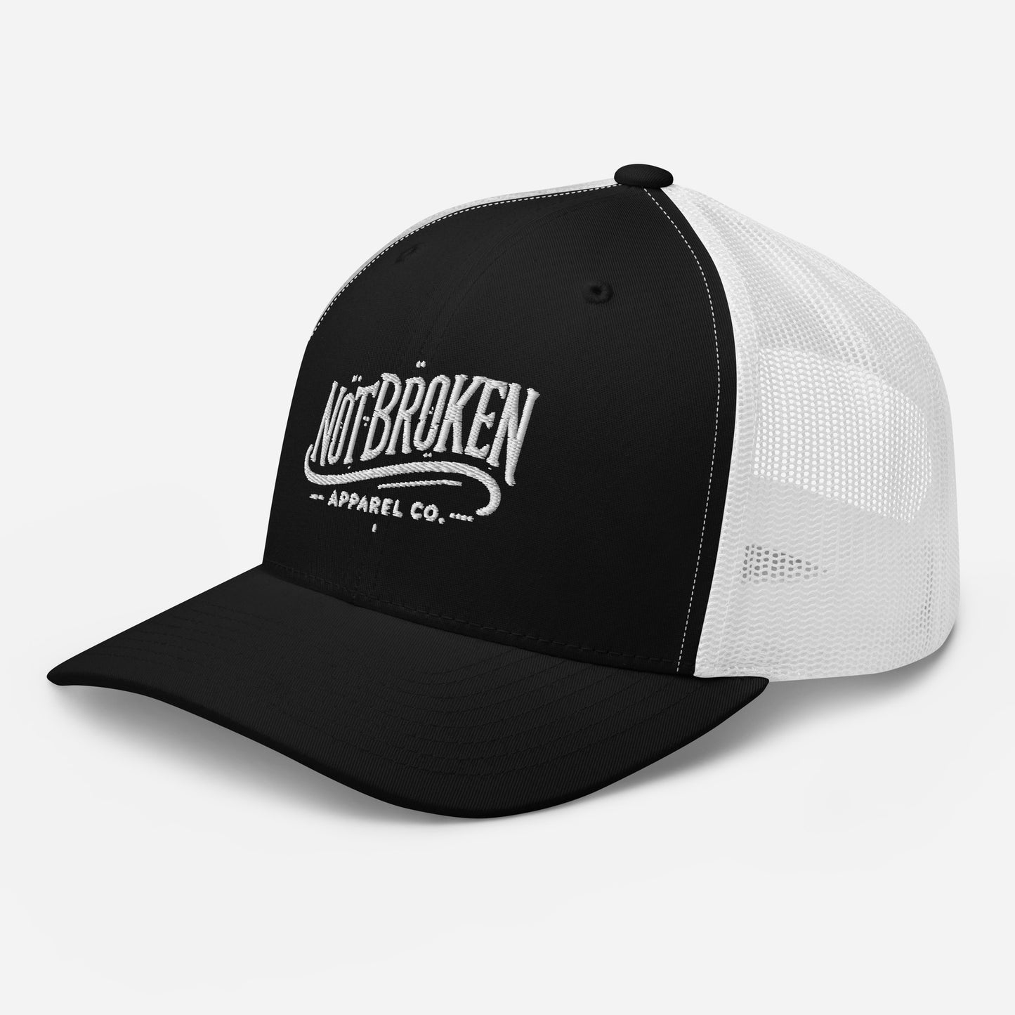 Premium black and white Not Broken Trucker Cap with white embroidered logo and breathable mesh back, tactical headwear.