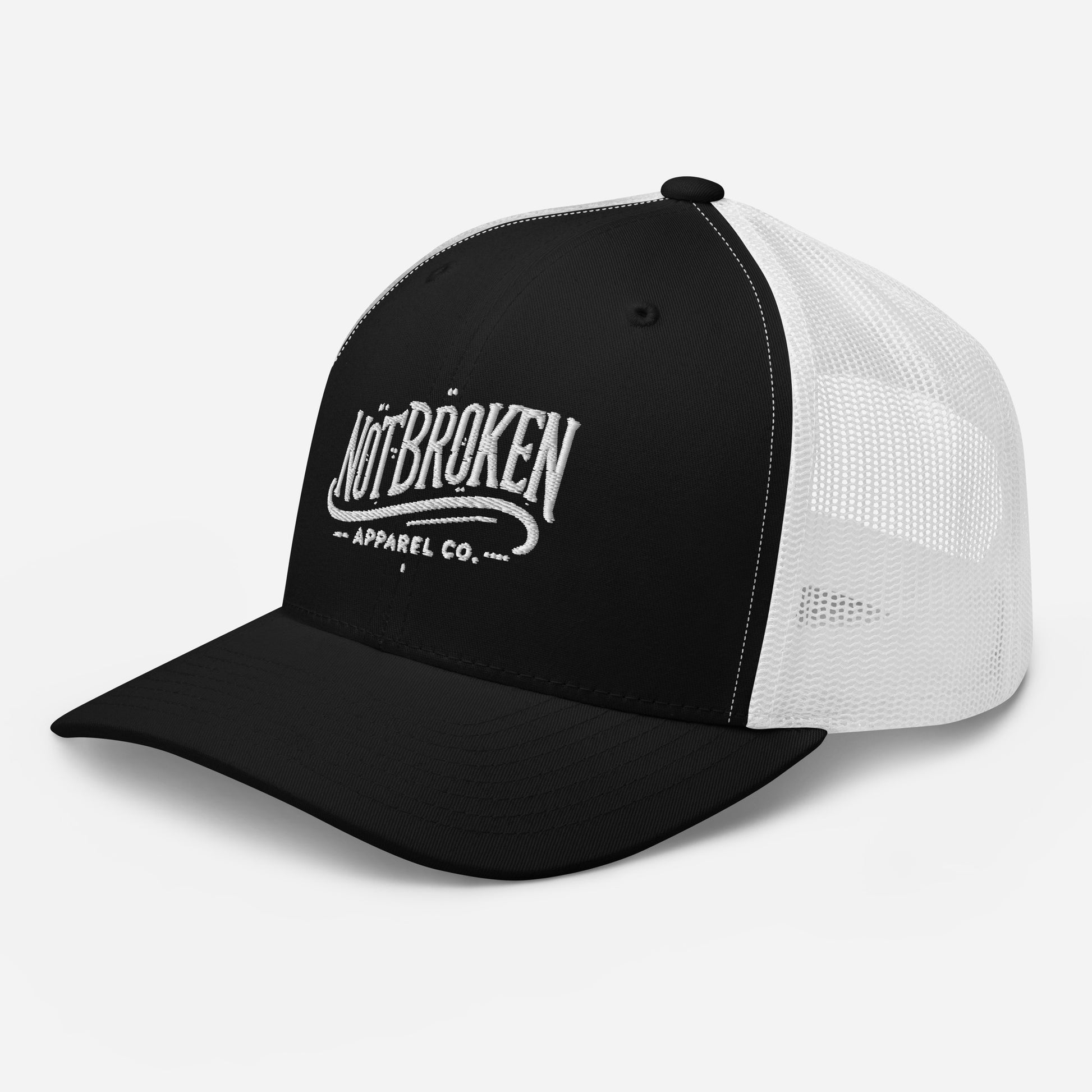Premium black and white Not Broken Trucker Cap with white embroidered logo and breathable mesh back, tactical headwear.